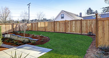 a newly installed fence in the back garden of a home