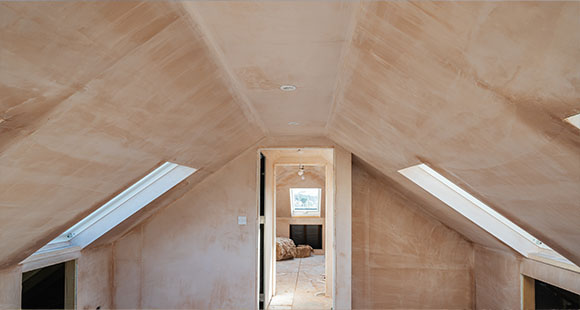 a loft conversion under construction with exposed plywood